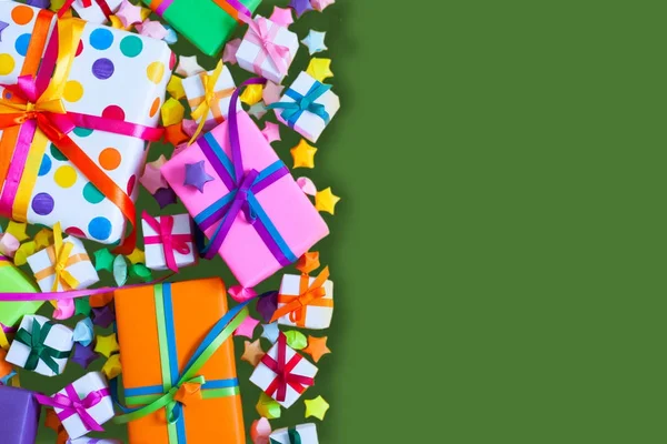 Renkli hediye kutuları renkli şeritler. Yeşil arka plan. Hediyelik