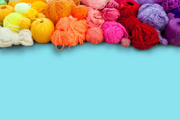 Colorful yarn stacked in a series of colors. Background blue. Ba — Stock Photo, Image