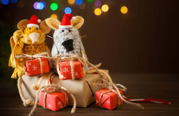 Крысы, вязанные из пряжи в рождественских шапках. Подарки, бюстгальтер — стоковое фото