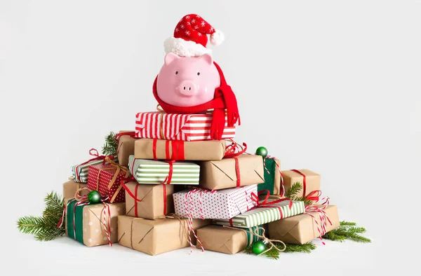 Sparschwein mit Weihnachtsmann-Hut. Weihnachtsgeschenkboxen. weißer Rücken — Stockfoto