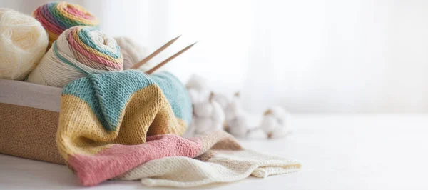 Tricot laine et aiguilles à tricoter aux couleurs pastel sur bac blanc — Photo