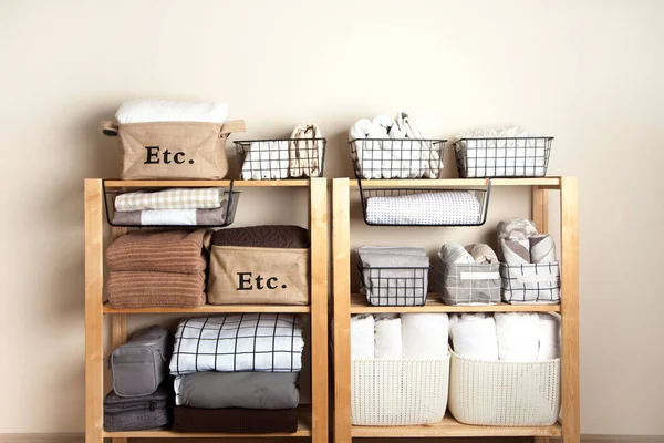 Bed sheets, duvet covers and towels are folded vertically. Metal