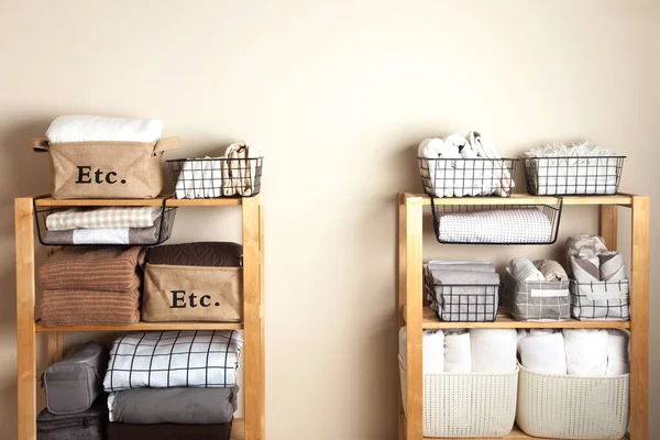 Bed sheets, duvet covers and towels are folded vertically. Metal