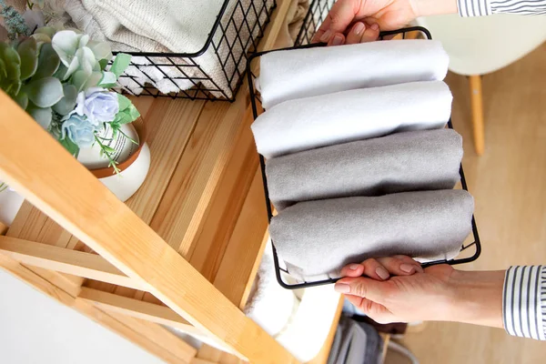 Bed sheets, duvet covers and towels are folded vertically. Metal