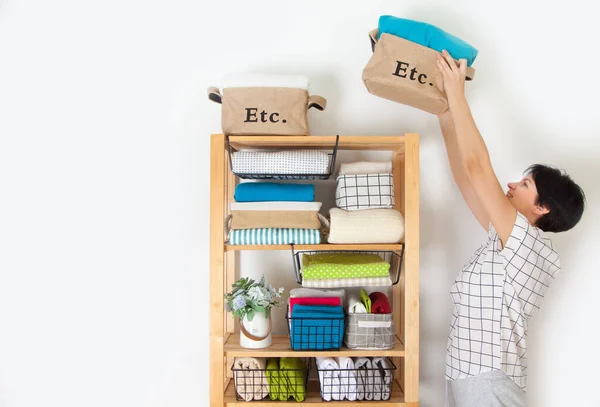 Bed sheets, duvet covers and towels are folded vertically. Metal