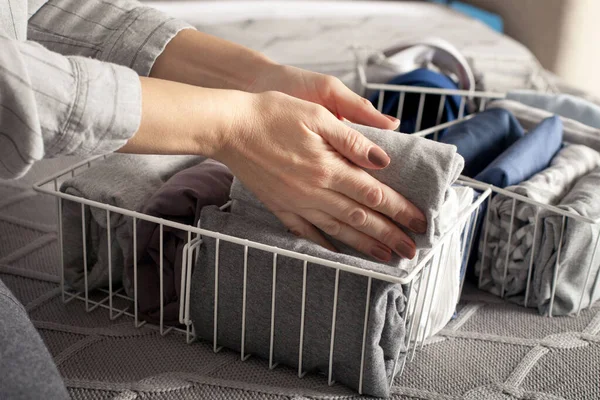 Woman Folds Her Clothes Puts Them Metal White Baskets Boxes — Stock Photo, Image