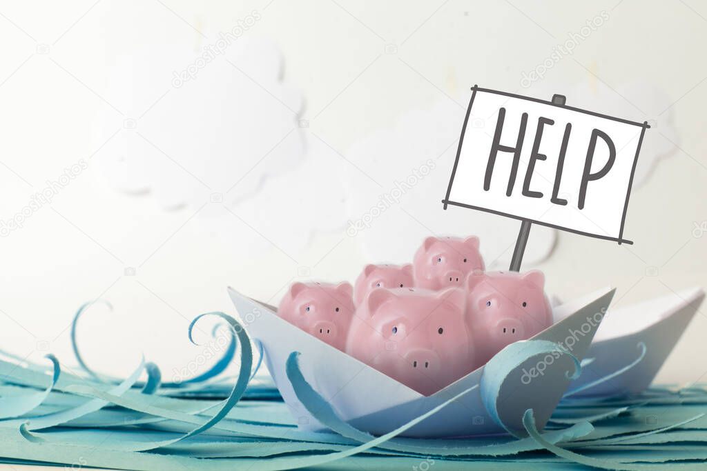 Pink piggy bank floating on paper boat on blue paper ocean and white cumulus clouds with sign Help. Concept of financial system crisis after coronavirus. Copy space
