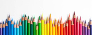 Crayons - colored pencil set loosely arranged  on white background. colored pencils are not arranged exactly in a row. clipart