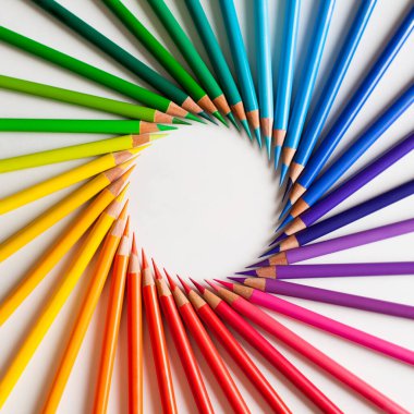 Crayons - colored pencil set loosely arranged  on white background. Round frame. clipart