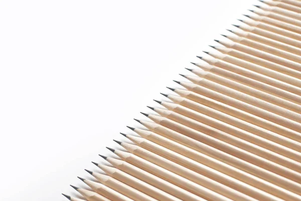 一排排锋利的铅笔在白色的背景上排成一排 被圆形的小号弄得模糊不清 办公用品的概念和理想的员工 广告空间 — 图库照片