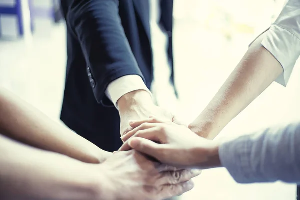 people showing unity with their hands together, teamwork and tog