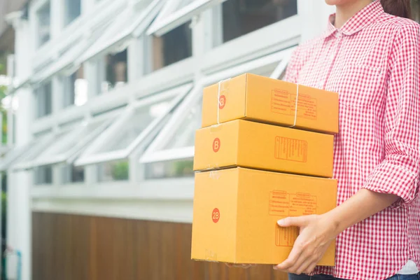 happy woman holding parcel of box for delivery, business owner concept