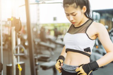 Spor salonunda kaslı vücut gösteren fitness kadını, spor konsepti, spor konsepti