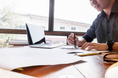 mühendisler plan üzerine bina işaret ve tasarım bina Proje çizim için dizüstü bilgisayar kullanarak ofis, inşaat konsepti. Mühendis kavramı