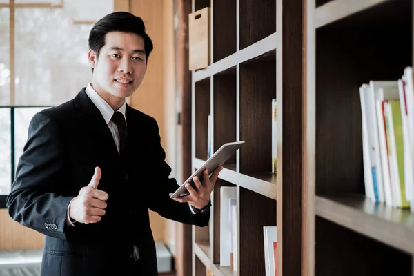 Young Businessman Standing Thumb Tablet Office Window Business Concept — Stock Photo, Image