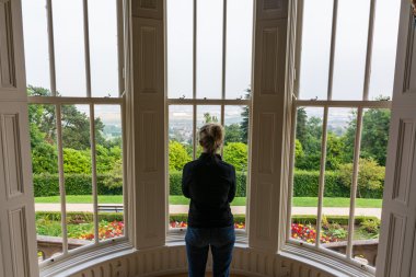 Woman Looking Out Window Thinking Belfast Castle North Ireland clipart