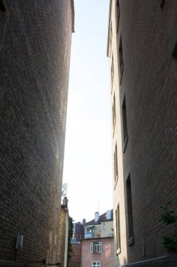 İki apartman binaları karanlık parlaktı arasında küçük sokak gökyüzü görünümü