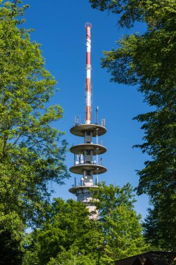 TV Tower on Blue Sky  with Green Trees background 