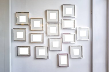 Multiple Many Blank Small Picture Frames on Wall
