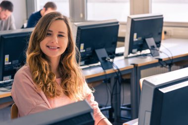 Young Student Girl  in Bright Computer Lab University Classroom
