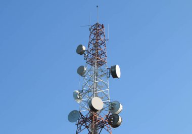 Telecommunication mast with microwave link and TV transmitter antennas. clipart