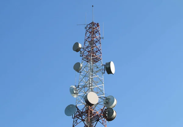 Telecommunication mast with microwave link and TV transmitter antennas.