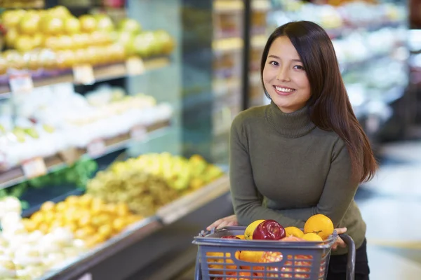 Genç Asyalı kadın süpermarkette alışveriş