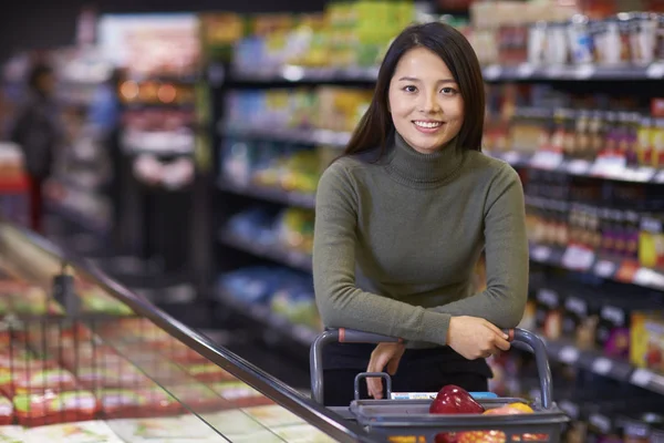 Young Asian Woman Shopping in the Supermarket