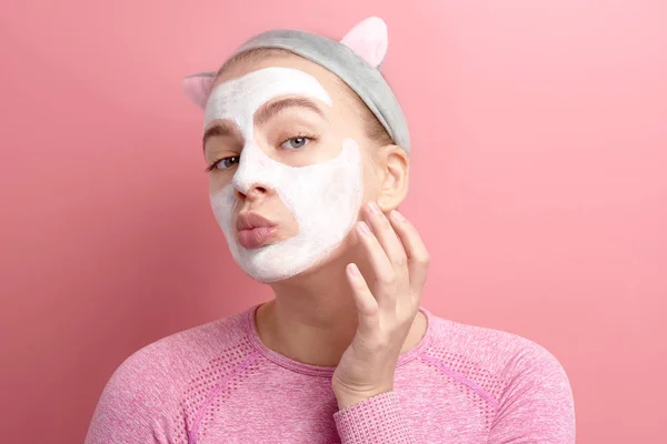 Young Woman Applying White Clay Cosmetic Mask Touches Face Looking — Stock Photo, Image