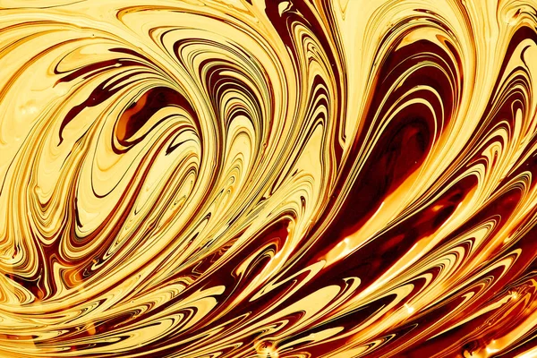 Abstract liquid gold background. Vibrant swirl pattern, stains of caramel paint