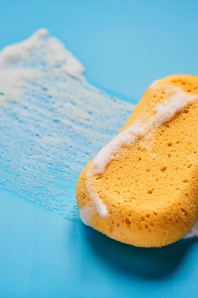 Yellow Washing Sponge Soap Foam Blue Background Isolated — Stock Photo, Image