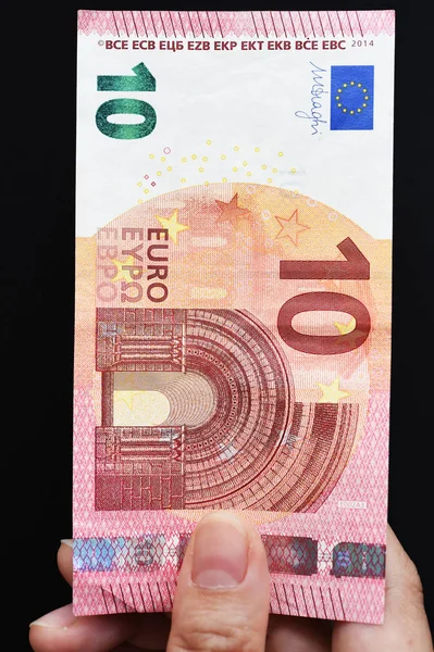 Dez notas de euro à mão — Fotografia de Stock