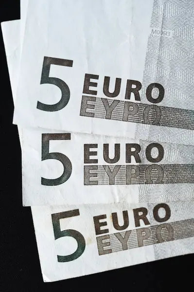 Cinco euros sobre fondo negro —  Fotos de Stock