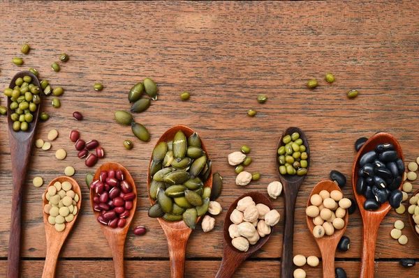 Assortment of beans and lentils in wooden spoon