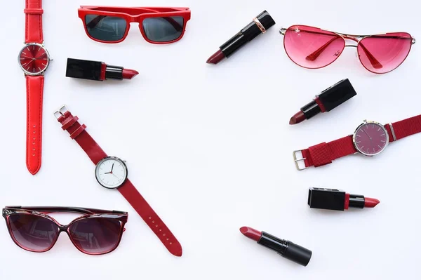 Set of color lipsticks with fashionable sunglasses and accessory isolated on white background