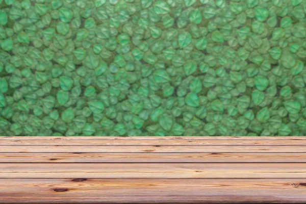 Green leaves wall and old wooden floor for background. You can be use for display or montage your products or food, etc.