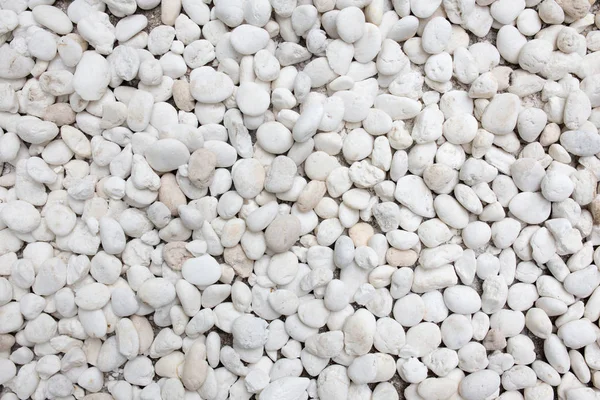 White pebble stones ground floor background texture.