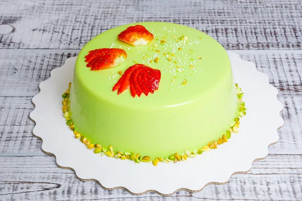 mirror glaze mousse cake with strawberries and pistachios