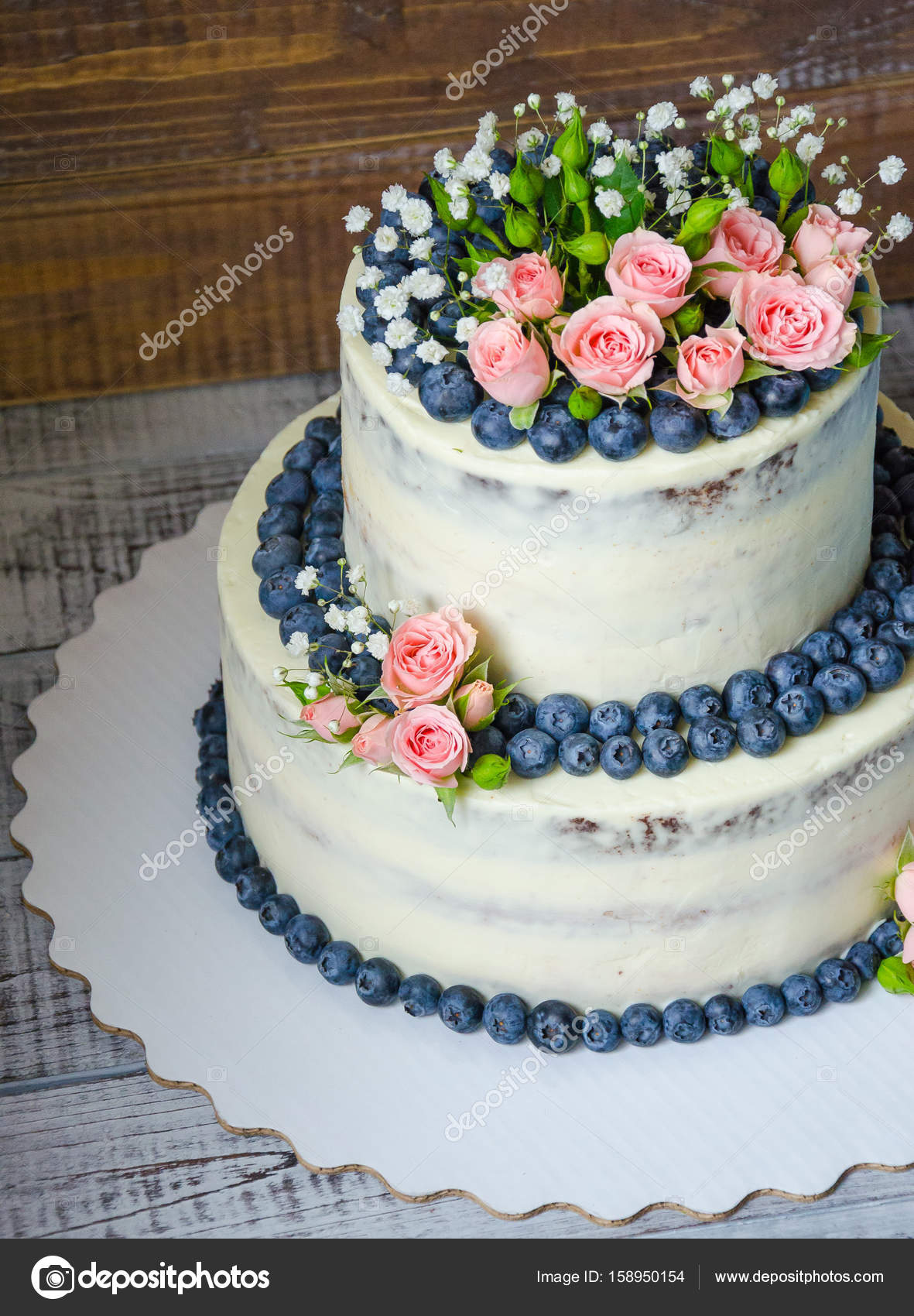 Gentle Wedding Cake With Blueberry And Roses Stock Photo