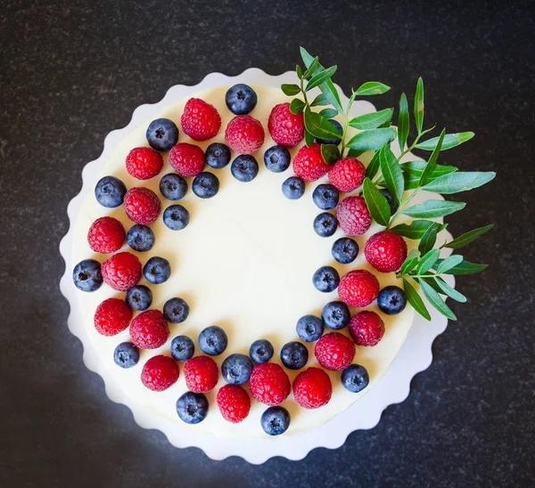 cream cheese cake with berries and eucalyptus