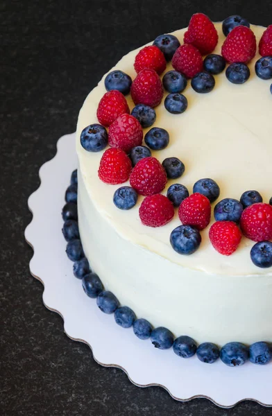 cream cheese cake with berries and eucalyptus