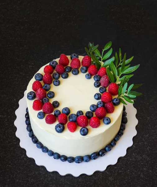 cream cheese cake with berries and eucalyptus