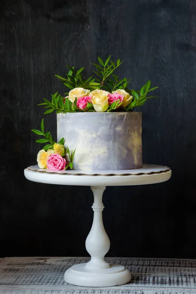 anniversary cake with roses on cake stand