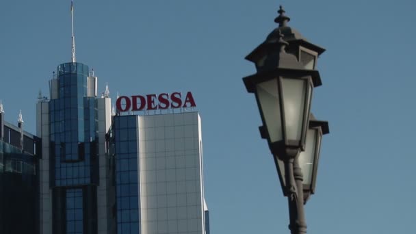 Lamp post with the tower of the Odessa Hotel — Stock Video