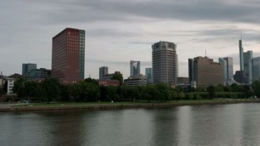 Yavaş geniş pan klibi Main Nehri ve Frankfurt manzarası Holbeinsteg Köprüsü arasında. Bir yaz sabahı şafakta alınan