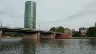 Frankfurt manzarası bir tramvay olarak şafak Westhafen Kulesi ve Friedensbrucke kamera tavalar geçer köprü