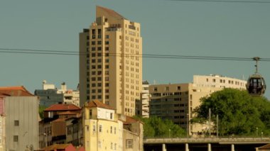 Uzun bir apartman bloğunun önünden geçen Porto Cable Car 'ın uzun bir görüntüsü.. 