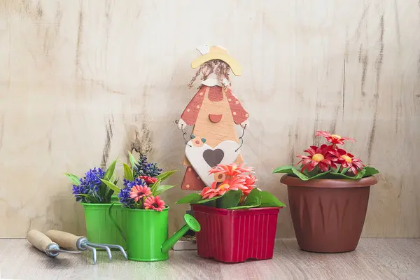 Spring gardening concept. Various flowers in flowerpots, waterin
