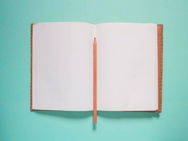 School notebook and pencil on a blue background