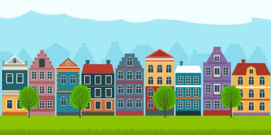 Summer cityscape with old european houses green grass and trees.
